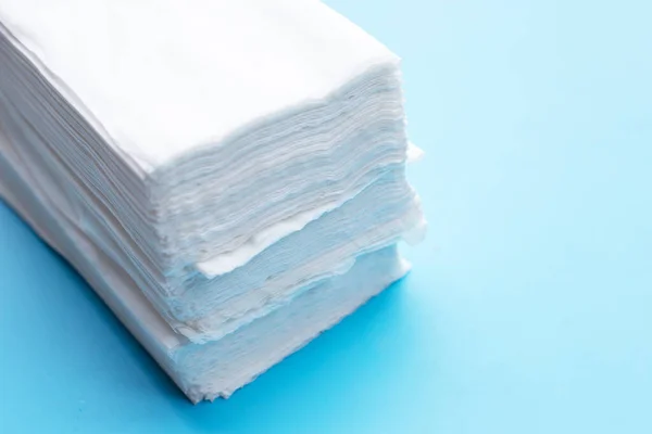 Facial tissue on blue background.