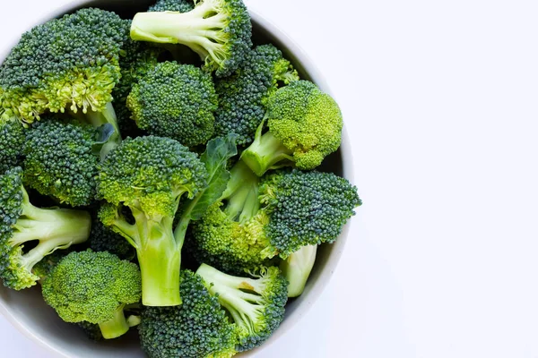 Broccoli in bowl on white background.