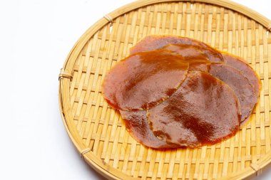 Dried mango paste sheets on white background.