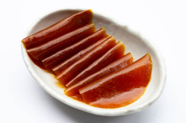 Dried mango paste sheets on white background.