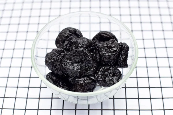 Dried prunes on white background