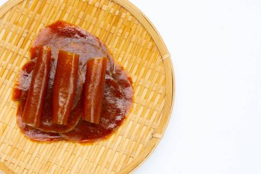 Dried mango paste sheets on white background.