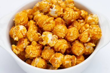 Beyaz arkaplanda bal karameli patlamış mısır.