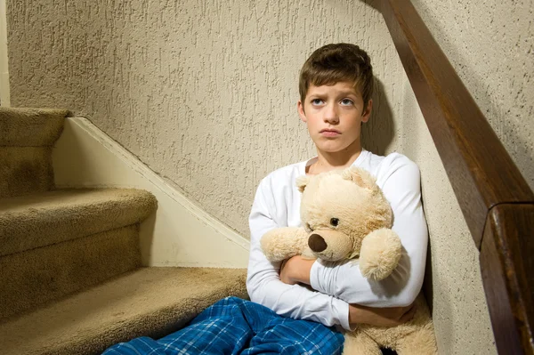 Sad and depressed boy in corner — Stock Photo, Image