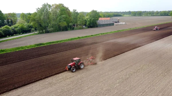 Farmer Plowing His Dry Farmland While Another Machine Right Busy — Zdjęcie stockowe