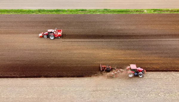 Farmer Plowing His Dry Farmland While Another Machine Left Busy — Zdjęcie stockowe