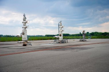 Three closed gas taps from a gas extraction location of the Groningen gas field near the village of Loppersum in the northern part of the Netherlands. clipart