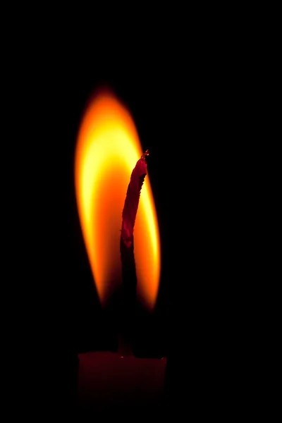 Closeup of burning candle isolated on black background — Stock Photo, Image