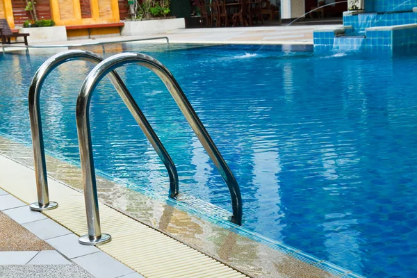 Grab bars ladder in swimming pool Stock Photo