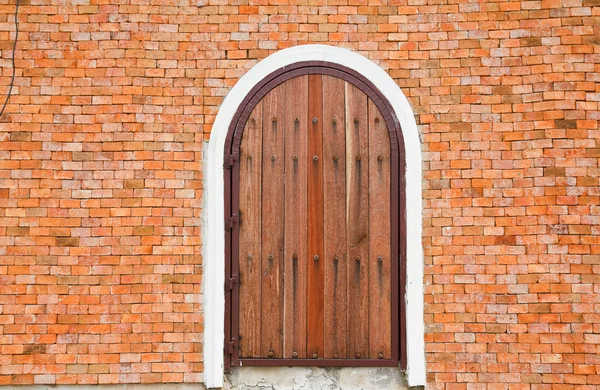 Houten deur op een bakstenen muur. — Stockfoto