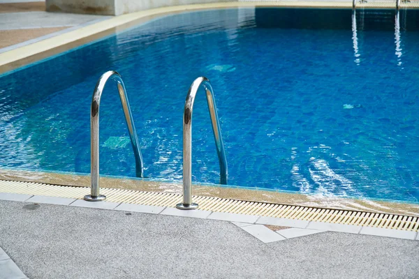Grab bars ladder in swimming pool Stock Image