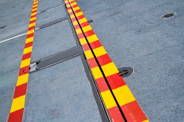 Red yellow line on the steel floor. — Stock Photo, Image