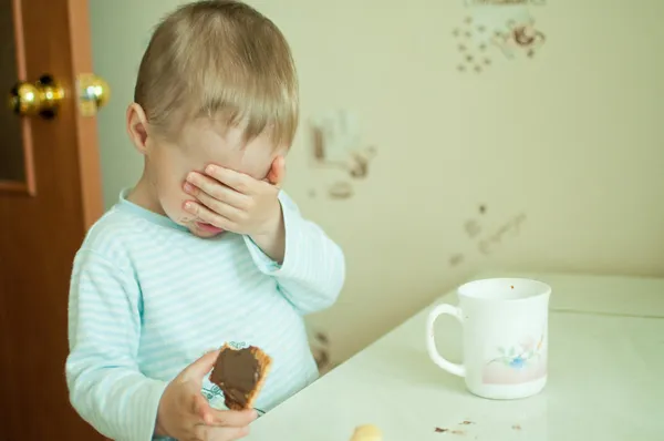 Child eats with tears Stock Picture