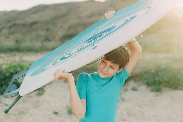 Child Jokingly Rides Ironing Board Instead Surfboard — стоковое фото