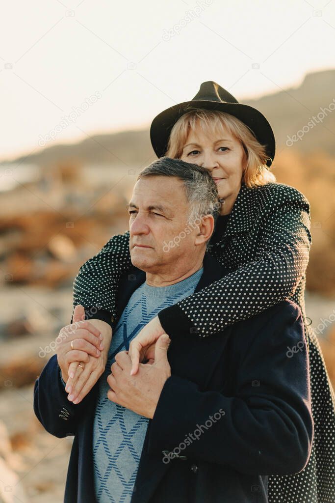 family elderly couple on a walk in autumn clothes