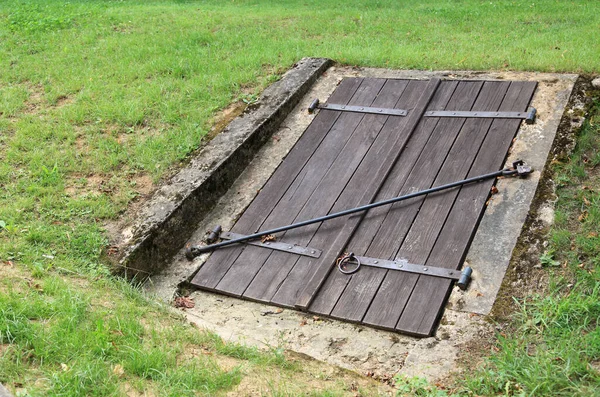 Old closed wooden entrance to an underground cellar