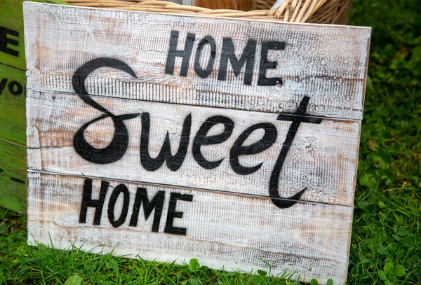 Old weathered sign with the phrase 