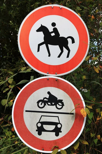Two traffic signs for prohibition of motorcycles, cars and horse riding