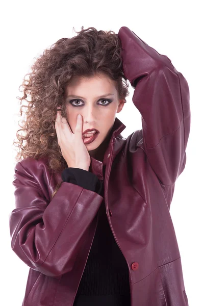 Beautiful woman, with curly hair holding her hair, with with his tongue out and a winter coat — Stock Photo, Image