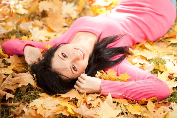 Sonbahar parkta oturan genç güzel kadın — Stok fotoğraf