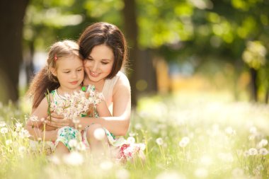 Mother and daughter in the park clipart