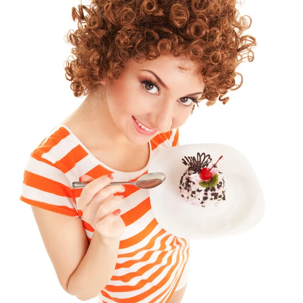 Fun woman eating the cake on the white background — Zdjęcie stockowe