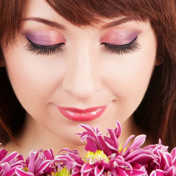 Portrait of a young beautiful woman with flowers — Stock Photo, Image