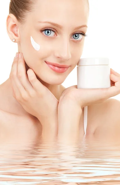 Cute woman applying cream to her face — Stock Photo, Image