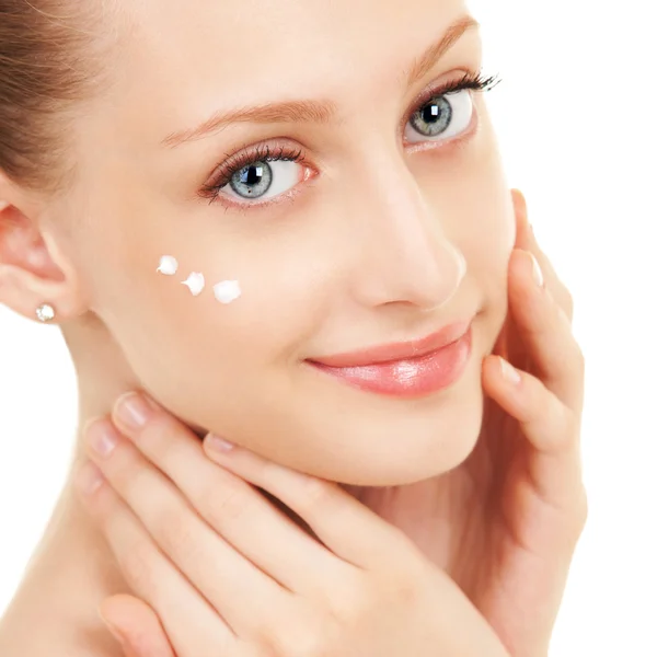 Cute woman applying cream to her face — Stock Photo, Image