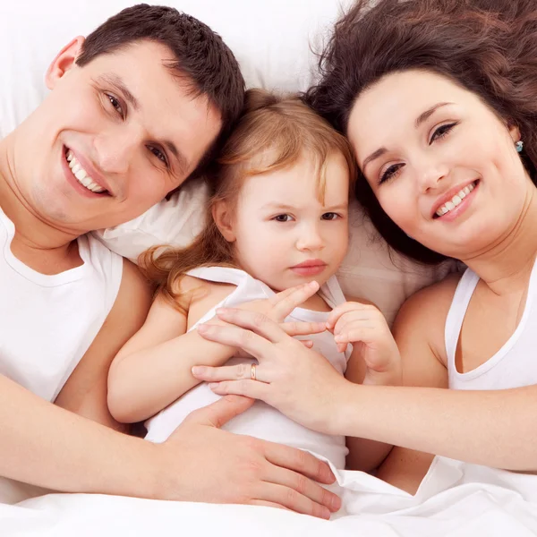 Felice famiglia, madre, padre e figlia che riposano sul bianco b — Foto Stock