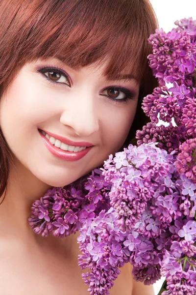 Jovem com flores no fundo branco — Fotografia de Stock