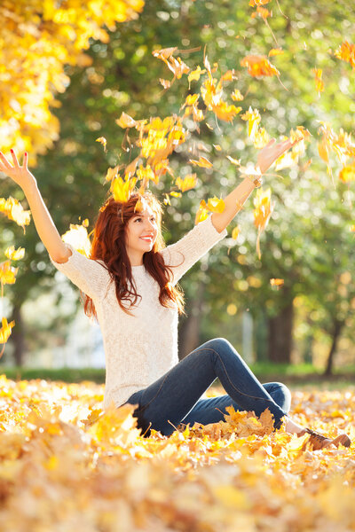 Young pretty woman in the autumn park