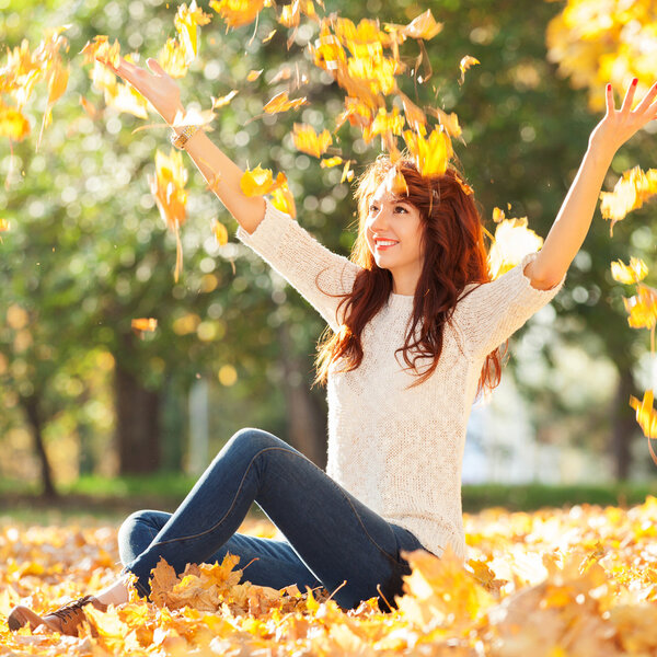 Young pretty woman in the autumn park