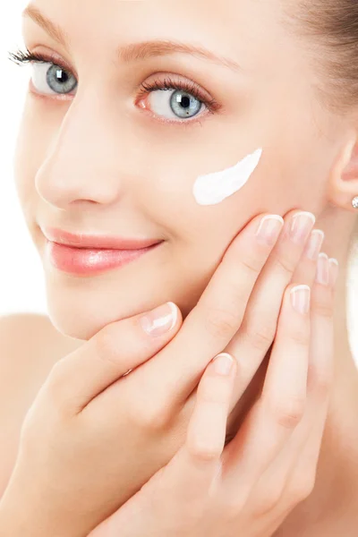 Carino donna applicando crema al suo viso — Foto Stock