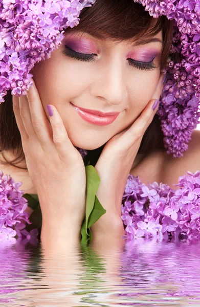 Young woman with lilac flowers — Stock Photo, Image