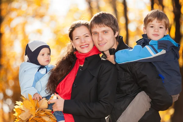 Happy family in the autumn park — Stock Photo, Image