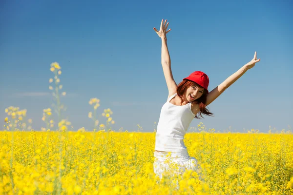 Happy woman in the field with flowers Stock Photo