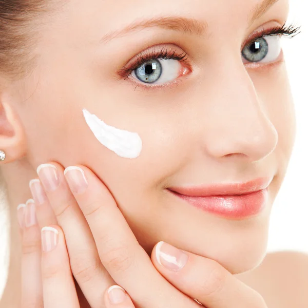 Cute woman applying cream to her face — Stock Photo, Image