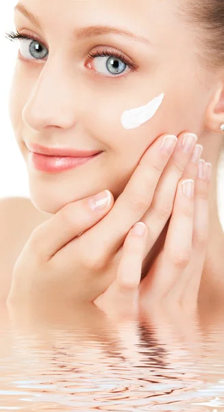 Cute woman applying cream to her face — Stock Photo, Image
