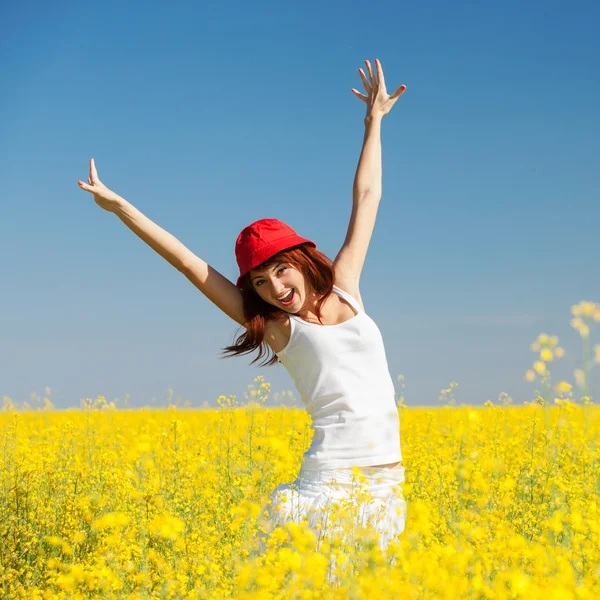 Happy woman in the field with flowers Stock Image