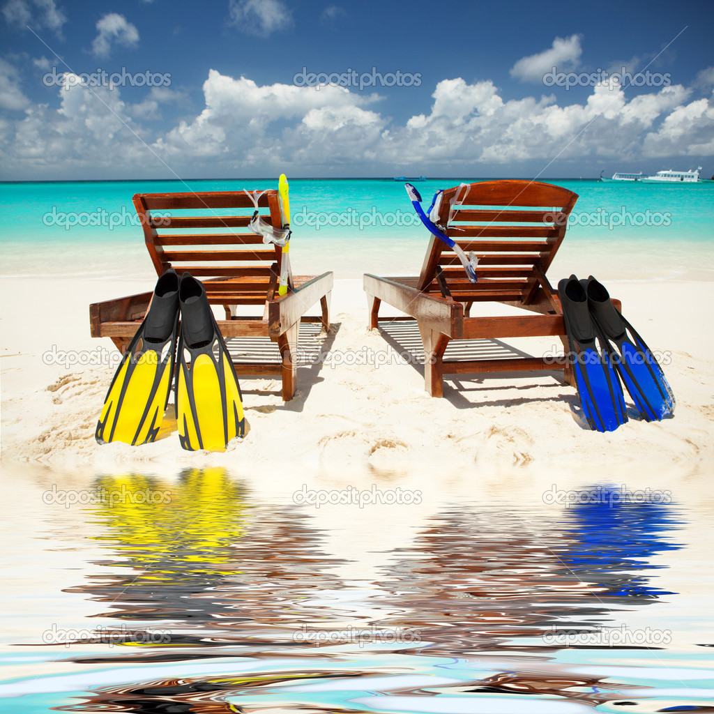 Two deckchairs on the tropical beach 