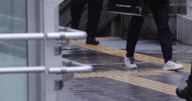 Şehirdeki sokakta yürüyen insanların yavaş çekimleri.