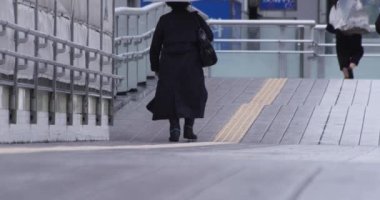 Şehirdeki sokakta yürüyen insanların yavaş çekimleri.