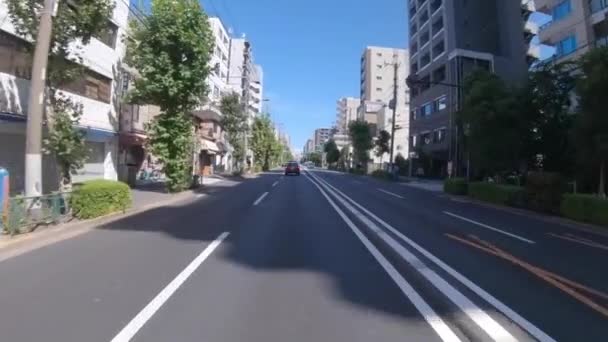 A pov of driving cityscape on the city street in Tokyo in summer wide shot — Stock Video