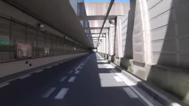 A pov of driving cityscape on the city street through the tunnel in Tokyo in summer — Stock Video