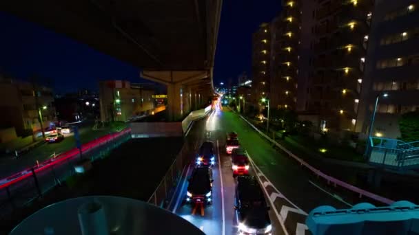Un timelapse nocturno de la calle de la ciudad en el centro de Setagaya Tokio zoom de tiro ancho — Vídeo de stock