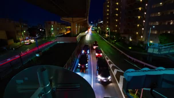 Un timelapse noche de la calle de la ciudad en el centro de Setagaya Tokio amplia inclinación tiro — Vídeos de Stock