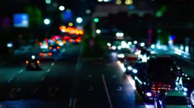 A night timelapse of the city street at the downtown in Setagaya Tokyo tilt-shit panning