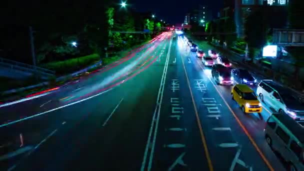 A night timelapse of the city street at the downtown in Setagaya Tokyo wide shot panning — Stock Video