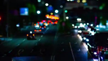 A night timelapse of the city street at the downtown in Setagaya Tokyo tilt-shit panning